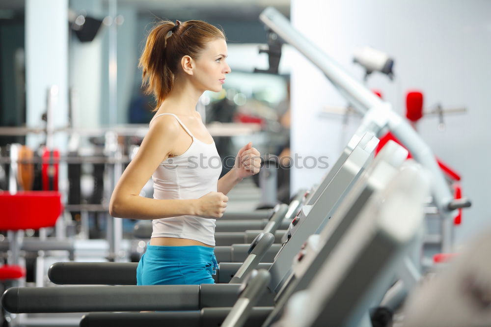 Similar – Woman drinking water while training on treadmill