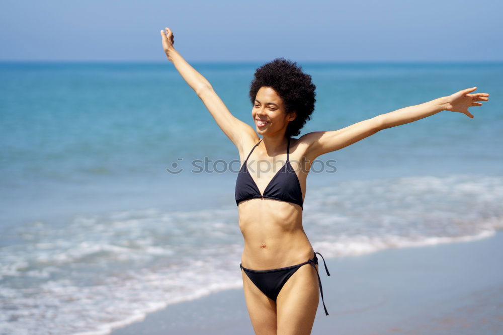 Similar – Young woman in bikini on a tropical beach with open arms.