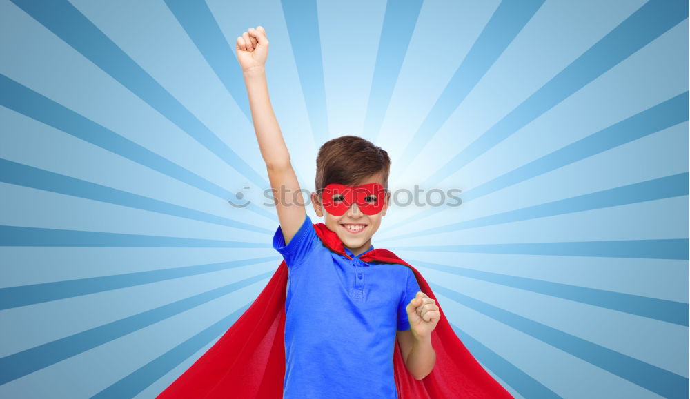 Happy little child playing superhero. Kid having fun outdoors. Concept of girl power.