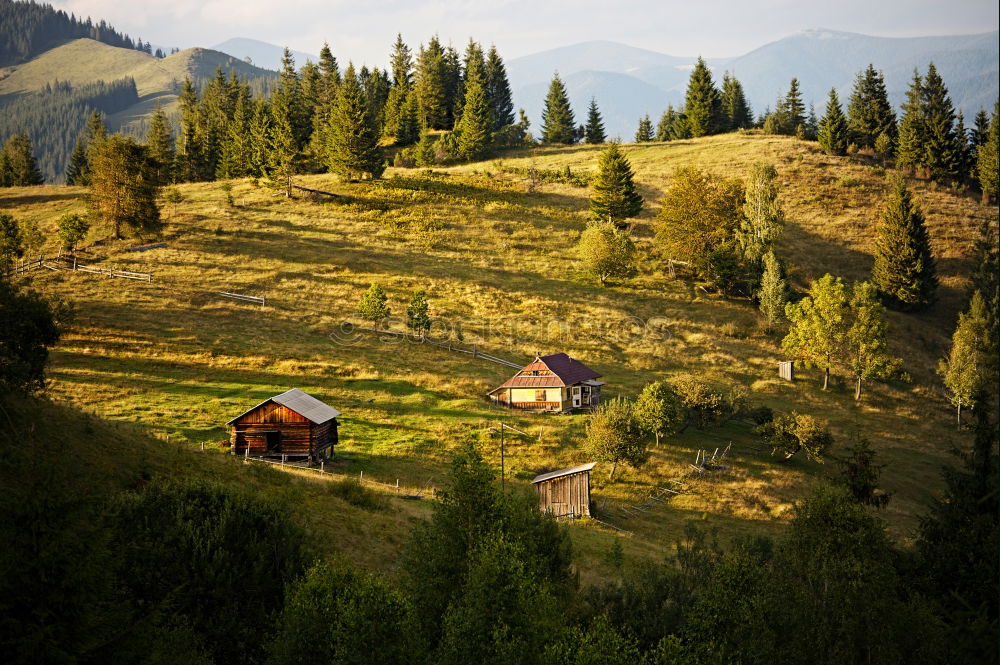 Similar – Mountains village on hillsides. Lone house on green hills