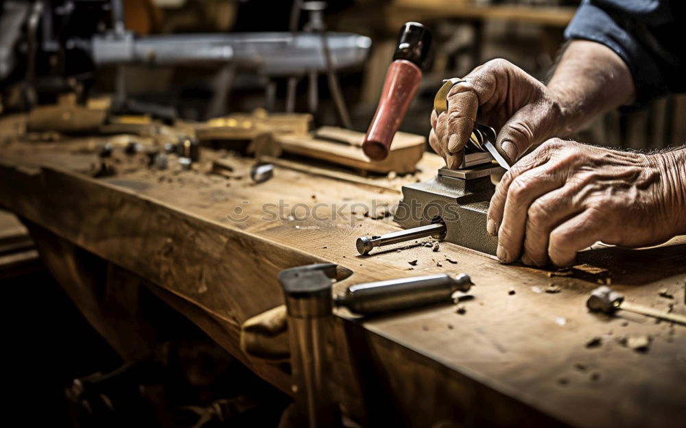 Similar – Carpenter with circular saw cutting a wooden plank