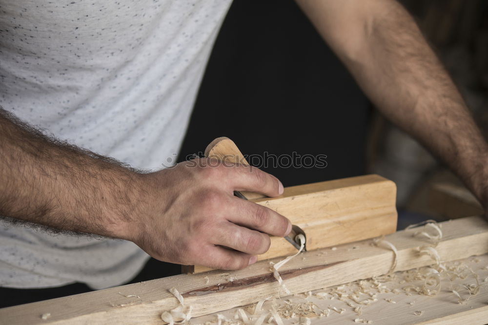 Similar – Carpenter with circular saw cutting a wooden.