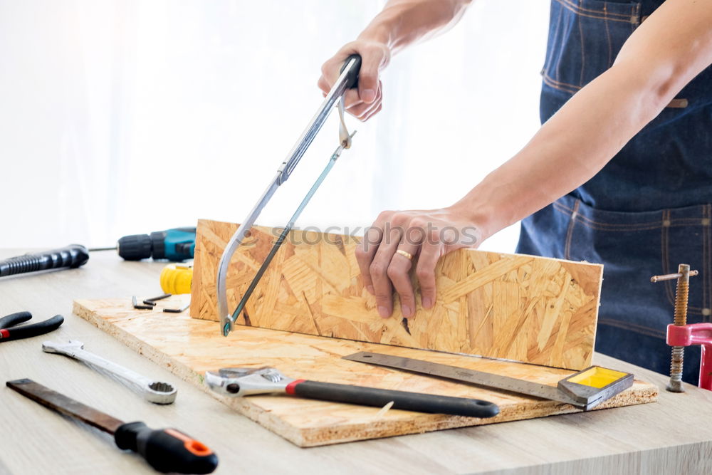 Similar – Image, Stock Photo Carpenter working with a chisel and a hammer.