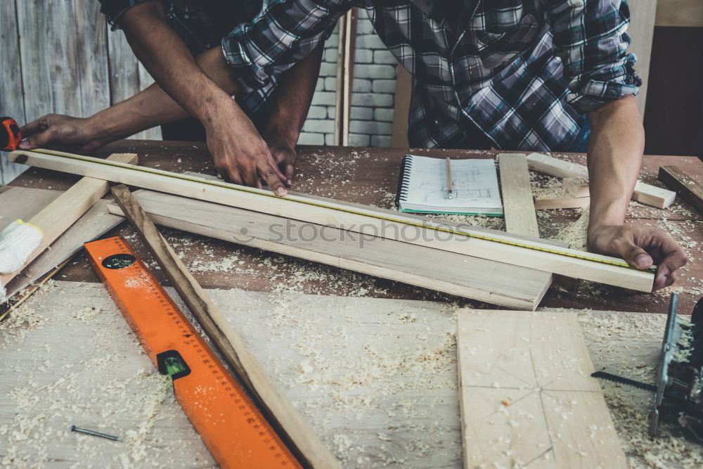 Similar – Carpenter with circular saw cutting a wooden.