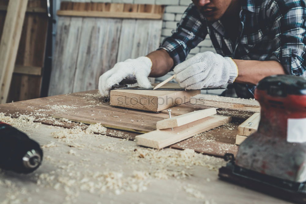 Similar – Image, Stock Photo Carpenter works with a chisel and a hammer.