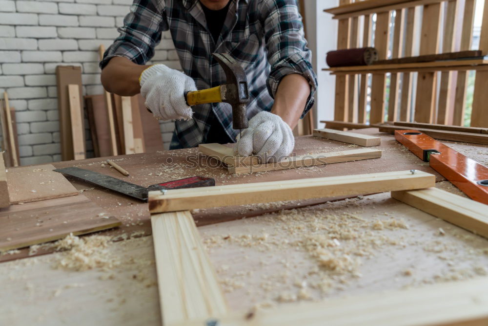 Similar – Professional carpenter with circular saw