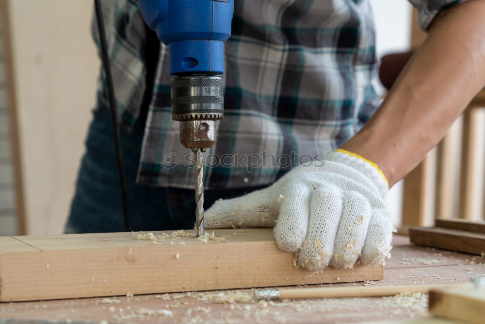 Similar – Image, Stock Photo Man drilling hole in timber while working in garden