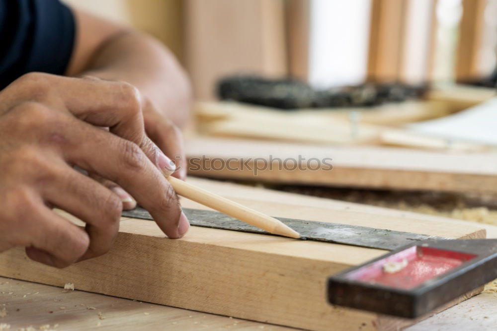 Similar – Image, Stock Photo Carpenter working with a chisel and a hammer.