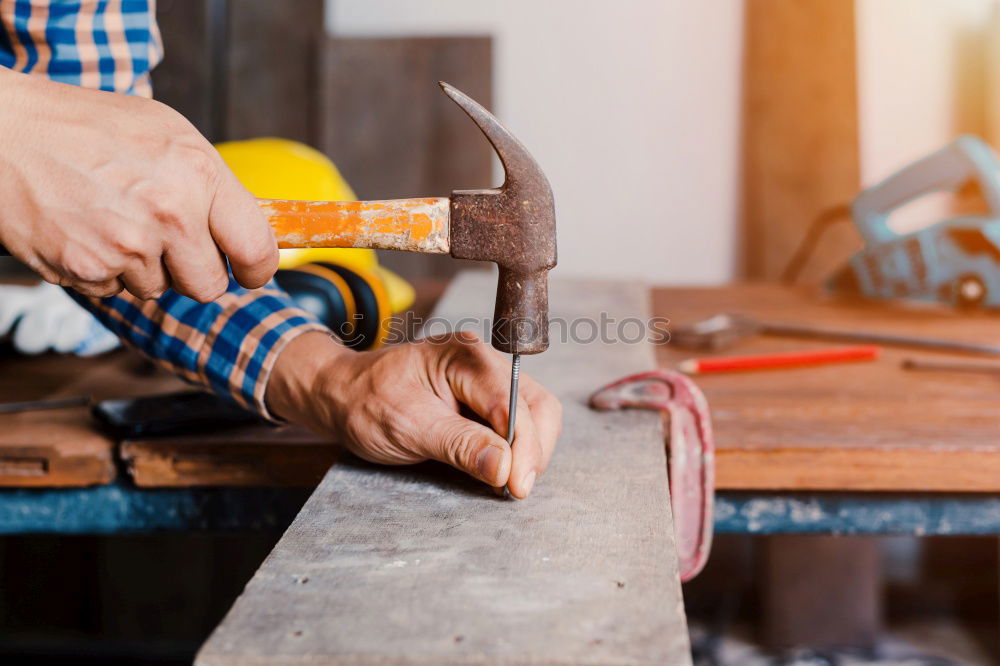 Similar – Man shoeing horse near stable