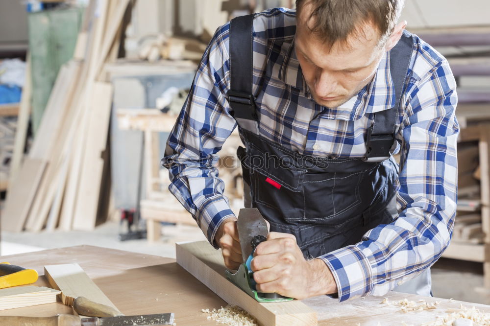 Carpenter cutting wooden board