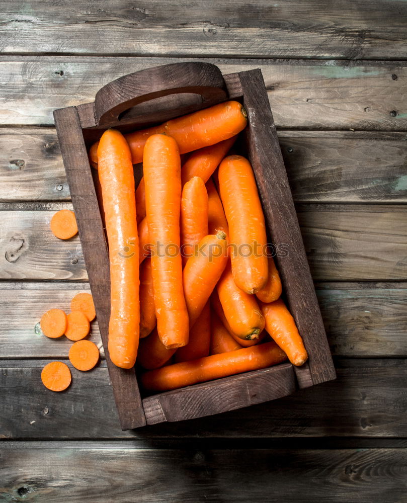 Similar – process of cutting slices of carrot on a kitchen board