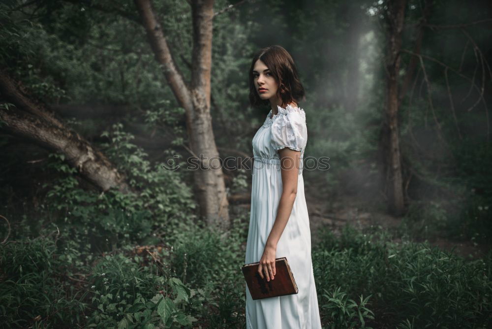 Similar – A Young Woman Standing in the Woods