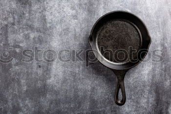 Similar – Black iron pan with a wooden handle and a spoon