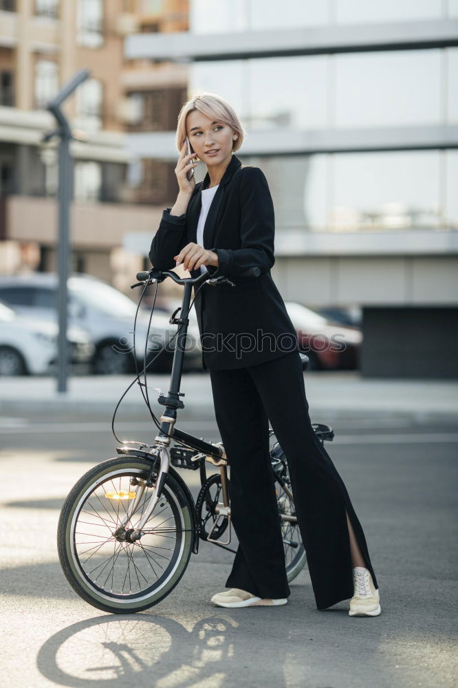 Similar – Woman sitting on an old blue scooter wearing red clothes.