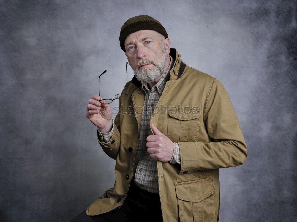 Happy man with a mustache in a knitted winter cap and warm winter clothing