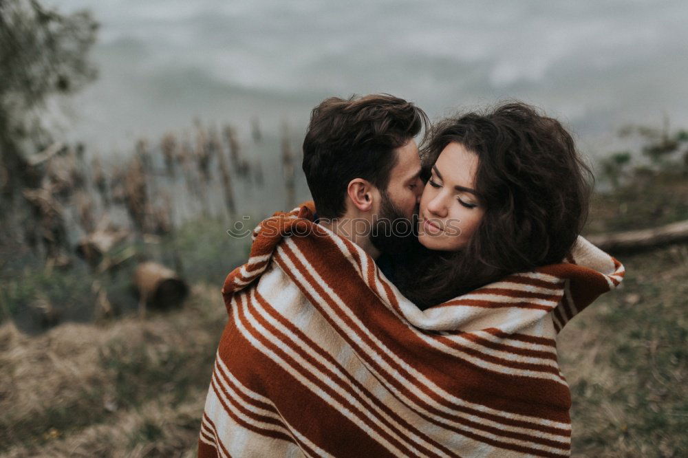 Similar – Blonde girl looks at camera while embraces her bearded boyfriend.