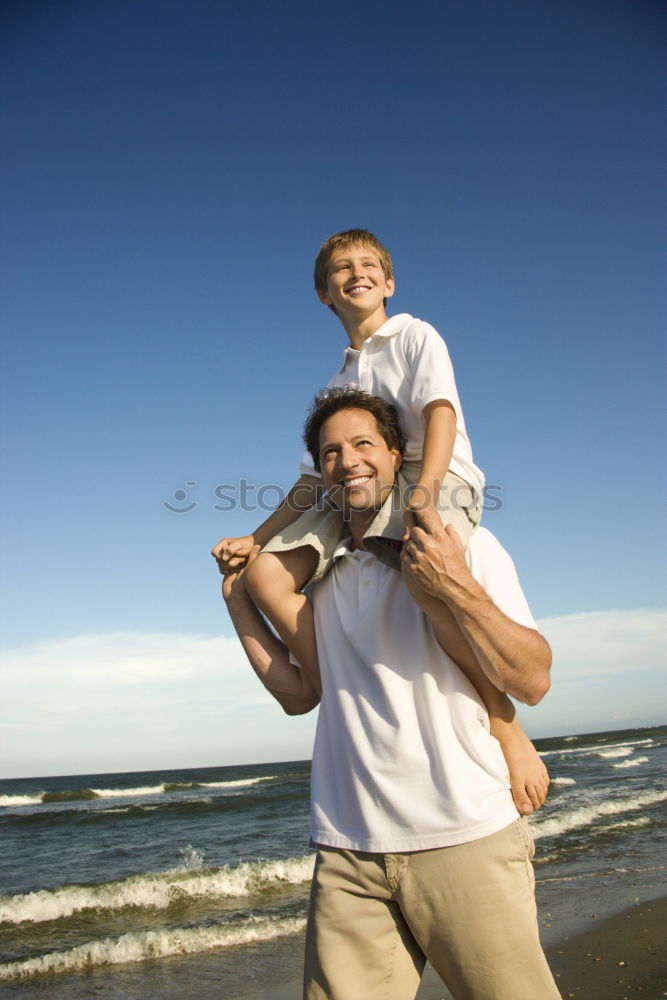 Similar – Image, Stock Photo Father and son playing superhero on the beach at the day time. People having fun outdoors. Concept of summer vacation and friendly family.