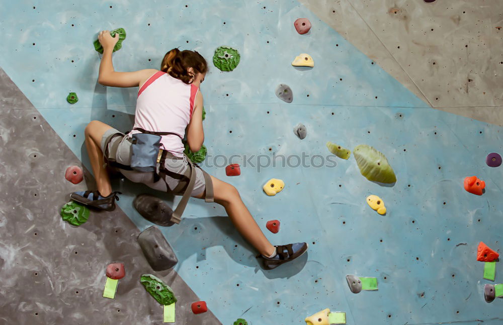 Similar – A Man practicing rock climbing on artificial wall indoors