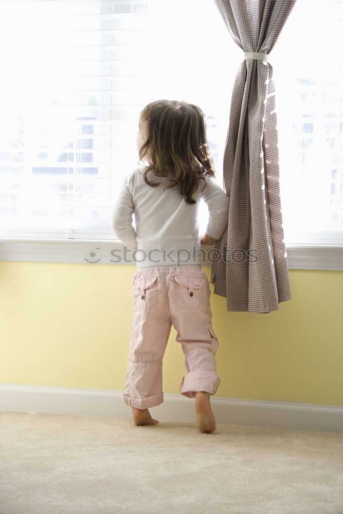 Image, Stock Photo Girl looks at dress against light from window