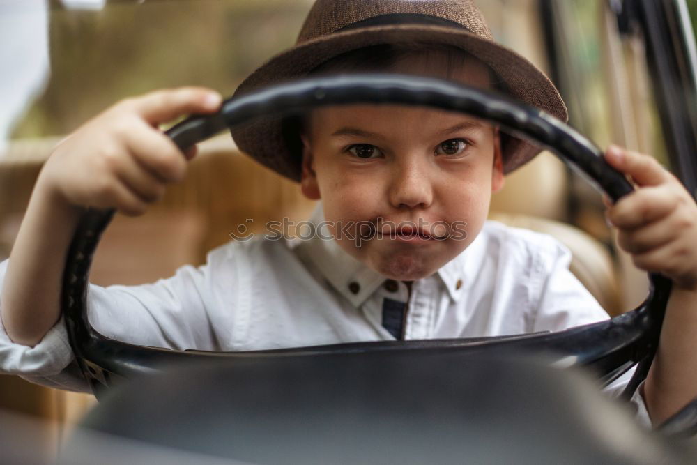 Similar – Image, Stock Photo funny child girl playing driver, sitting on front seat in car