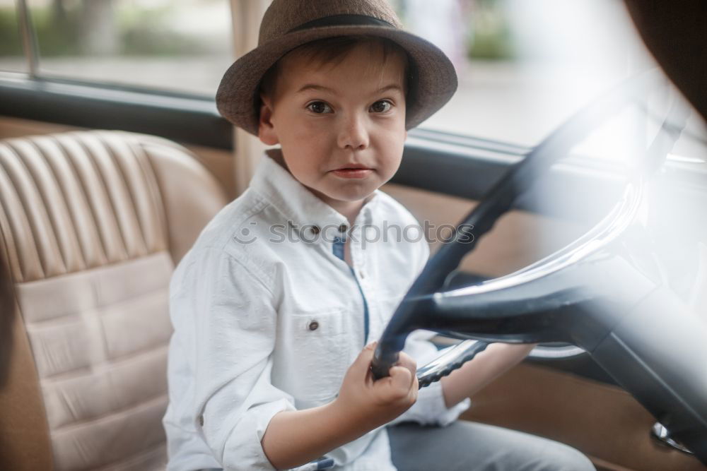 Similar – Image, Stock Photo funny child girl playing driver, sitting on front seat in car