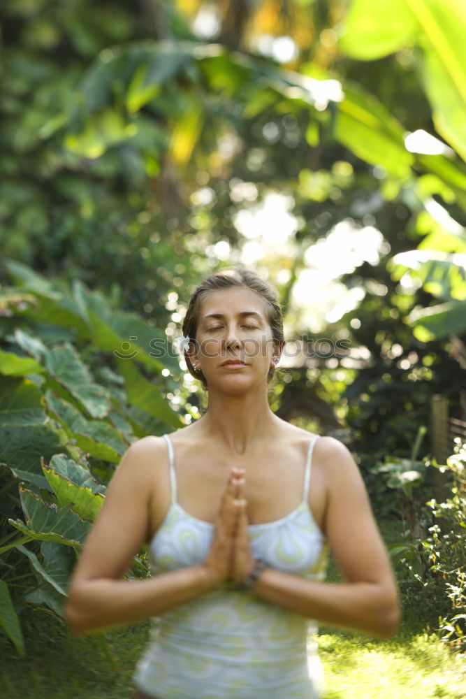 Young woman meditates in yoga asana Padmasana