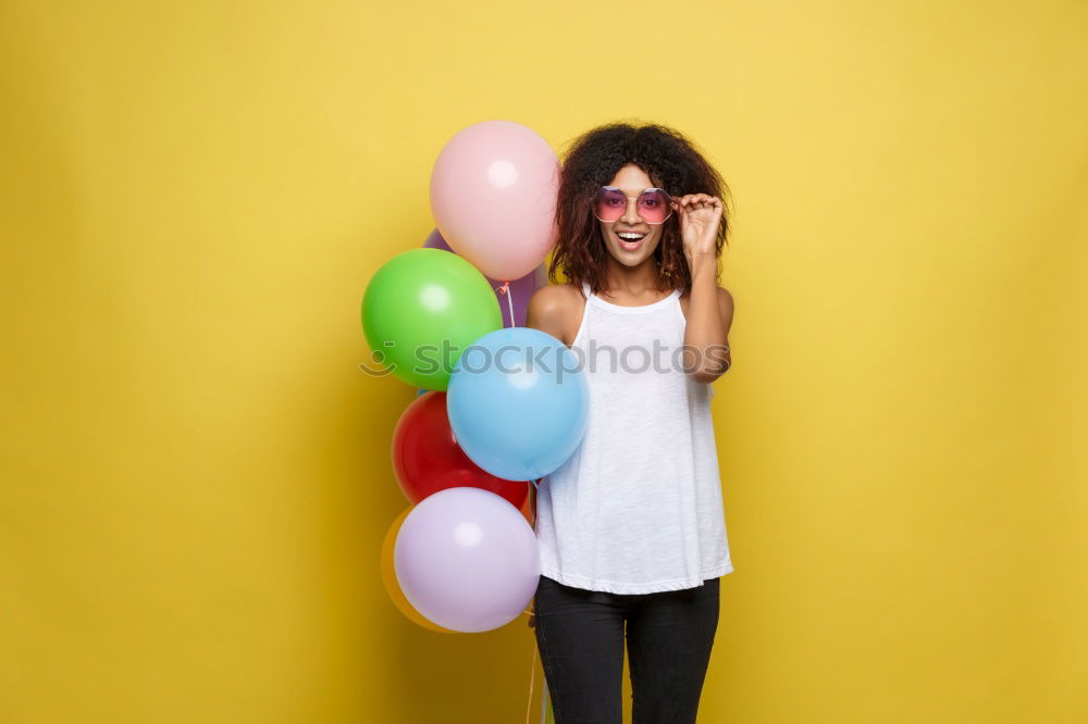 Similar – Black woman with afro hair celebrating with confetti.