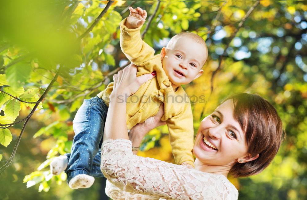 Similar – Image, Stock Photo Little baby is touching fresh spring leaves in her mother’s hug