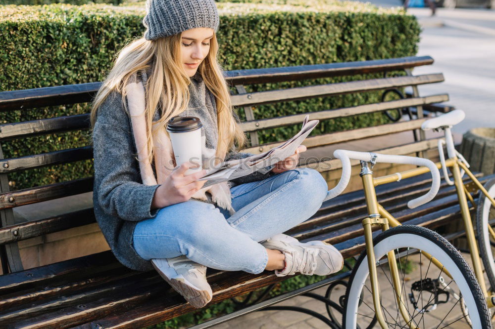 Attractive teenager sitting on steps in town