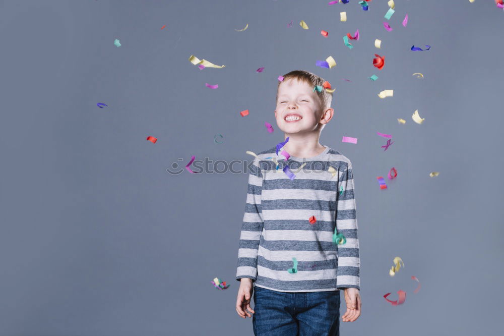 Similar – Child stands in a shower of confetti