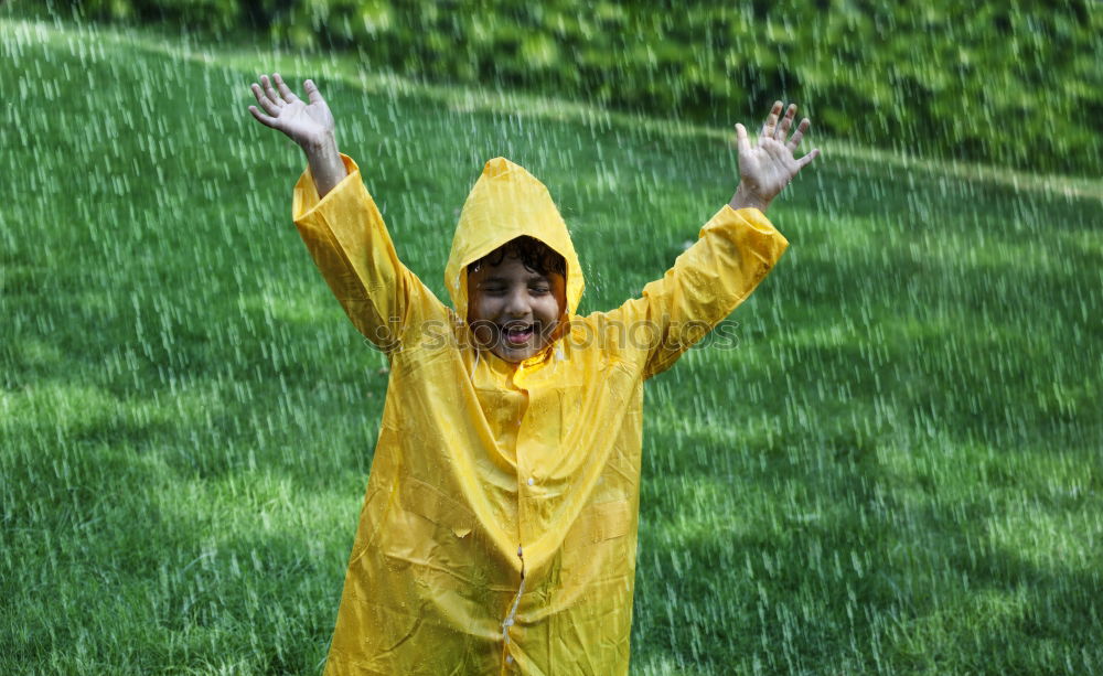 Similar – Little girl standing on rain wearing green raincoat