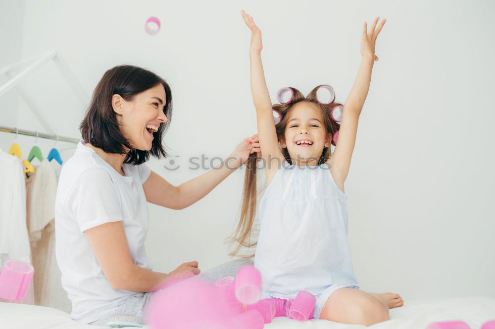 Similar – happy mother and child son fooling and playing in bed