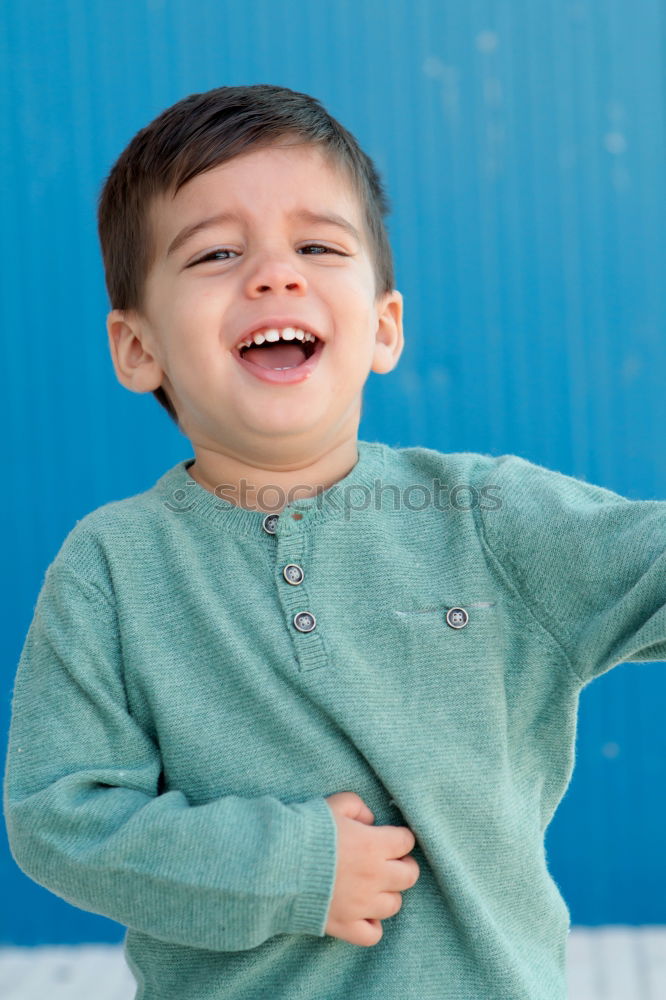 Portrait of a cute little boy on a village of an island greek