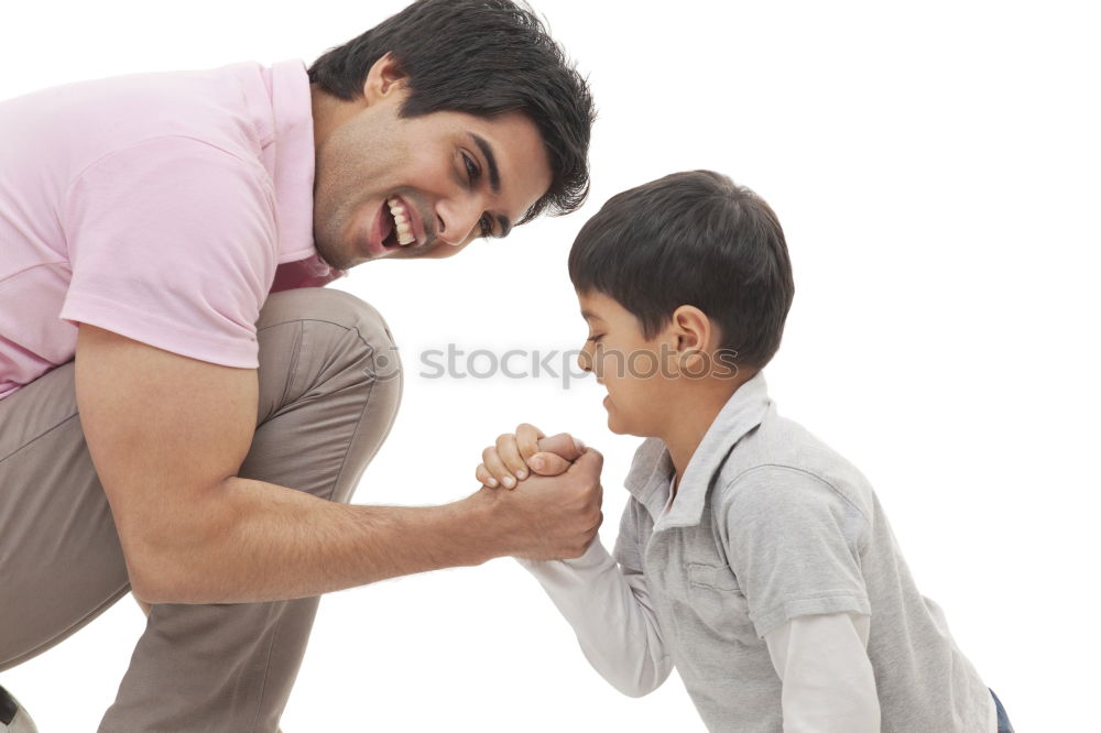 sad son hugging his dad near wall at the day time