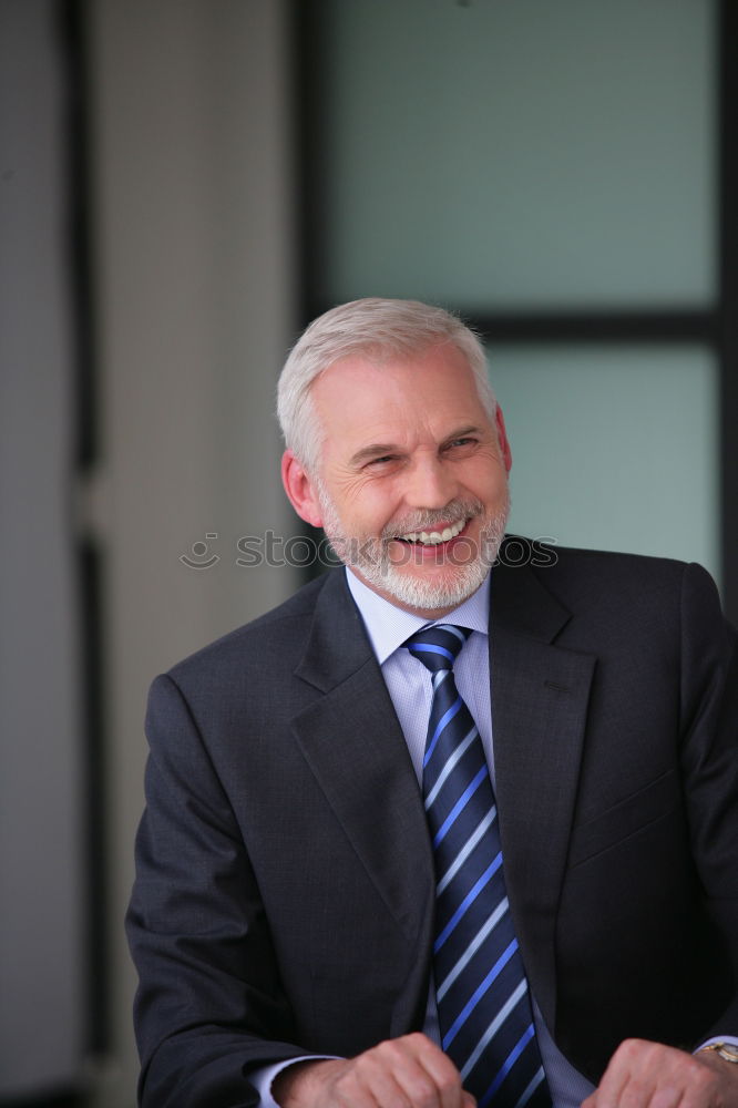 Senior businessman outside of modern office building.