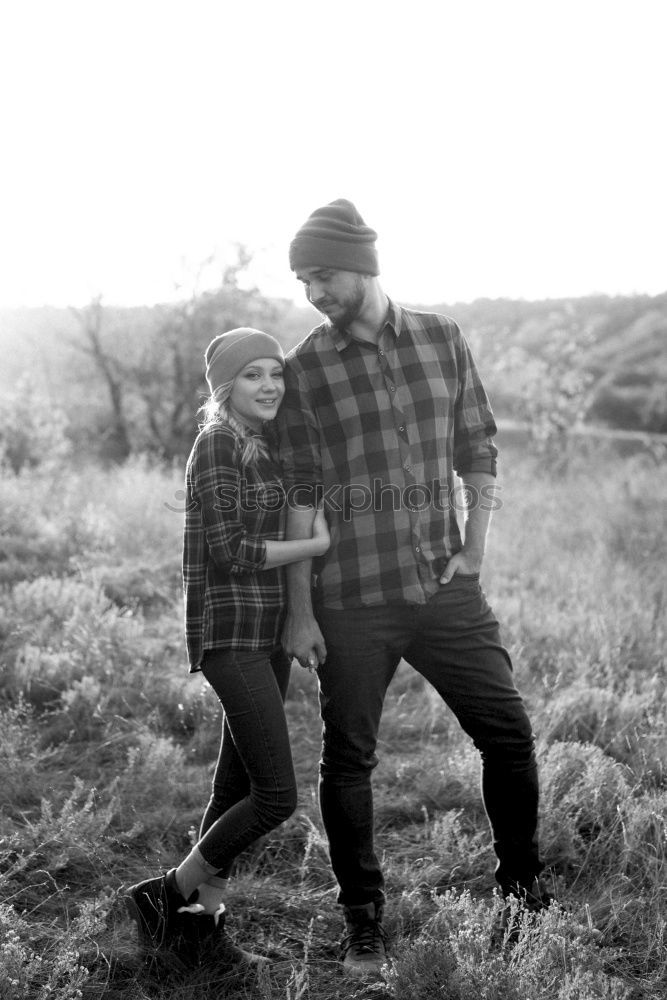 Similar – Bearded man carrying her girlfriend in a piggyback way outdoors at sunset.