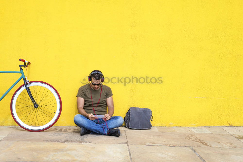 Side view of a young hipster man with a fixed bike