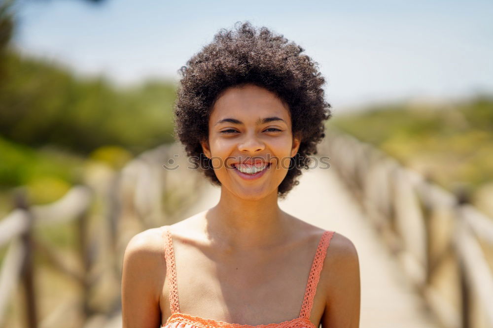 Similar – Young black woman with afro hairstyle smiling in urban park