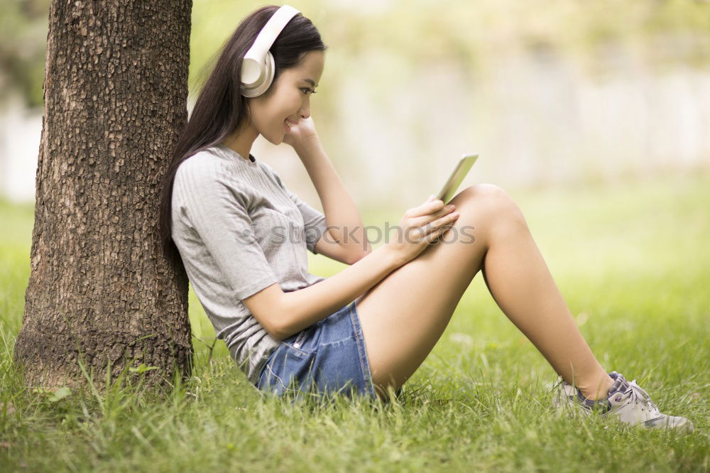 Similar – Image, Stock Photo Woman skateboarder listening music from smart phone in a park