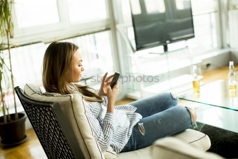 Similar – Mature woman sitting on couch at modern home