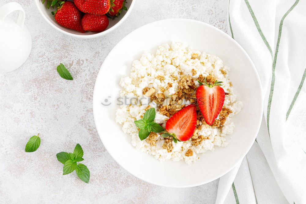 Similar – Image, Stock Photo Smoothie mango bowl with chia seeds yogurt pudding and cranberries, nuts, oatmeal topping in coconut shells with spoon. Healthy clean breakfast food. Copy space for your text or design