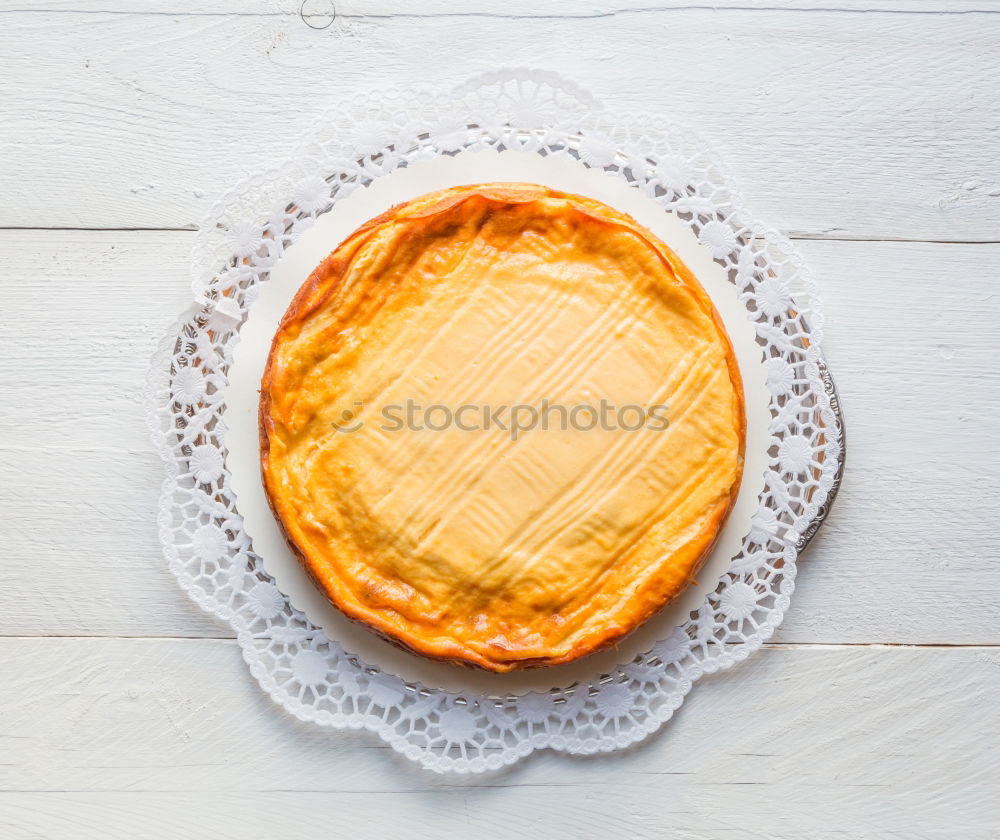 Cheese cake on white wood with cake tip