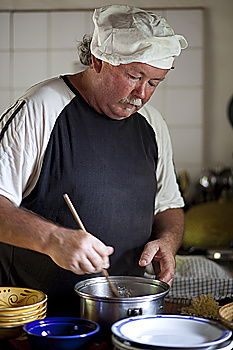 Similar – Carpenter with circular saw cutting a wooden plank