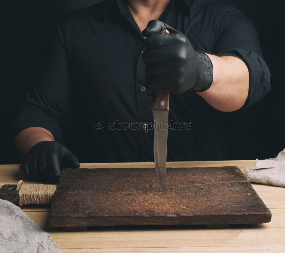 Similar – cook holding a stone mortar with pepper