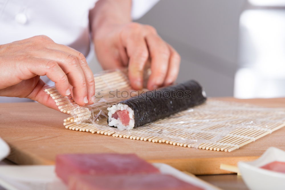 Similar – Woman chef hands rolling up japanese sushi