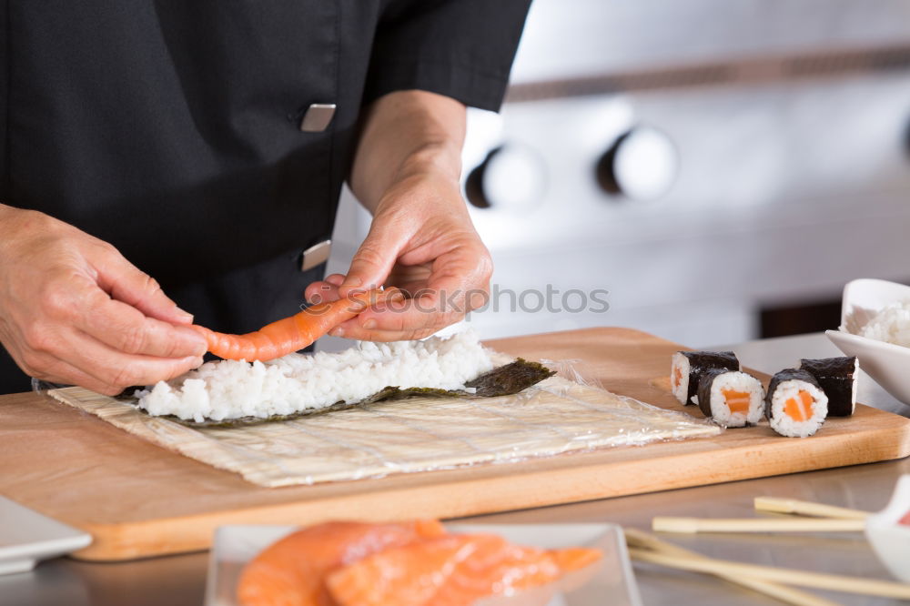 Similar – Woman chef hands rolling up japanese sushi