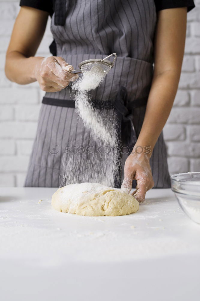 woman kneading bread dough with her hands