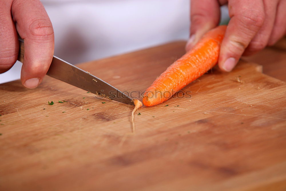 Similar – female human hand holding three large orange carrot