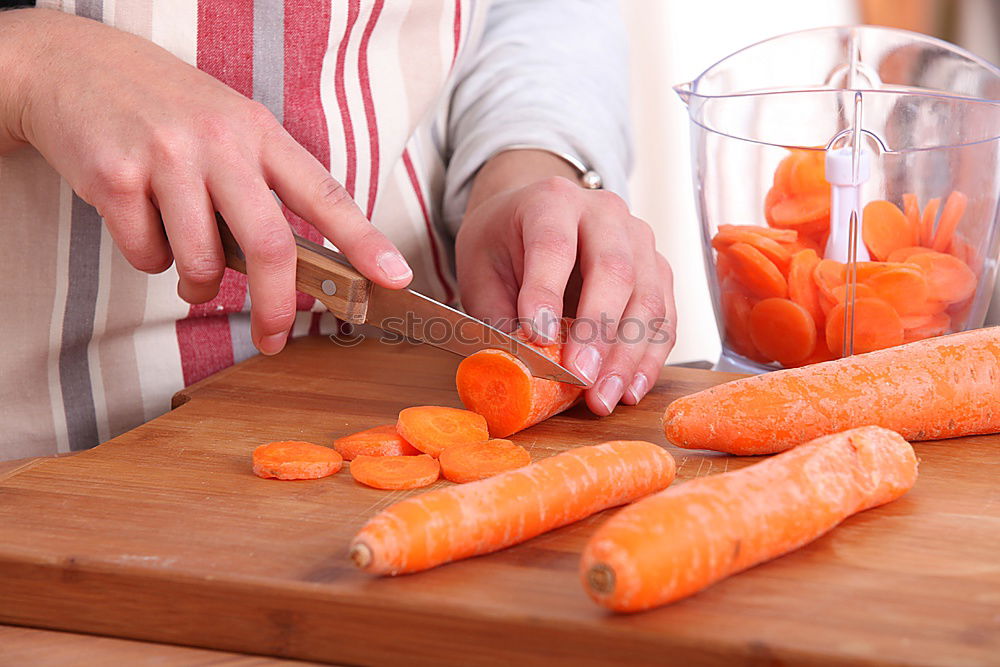 Similar – female human hand holding three large orange carrot