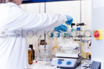 Similar – Worker putting liquid to test tube